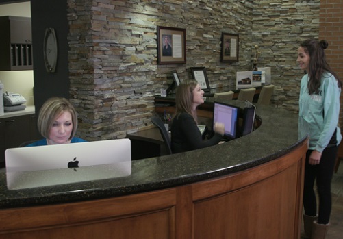 Patient smiling at dental assistant